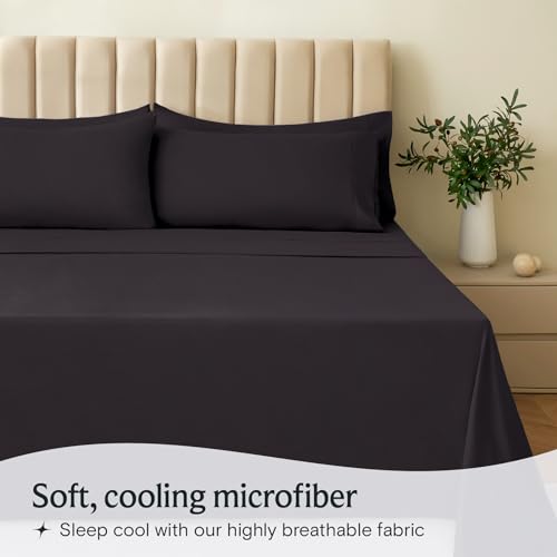 a bed with black sheets and a plant in a vase with text: 'Soft, cooling microfiber Sleep cool with our highly breathable fabric'