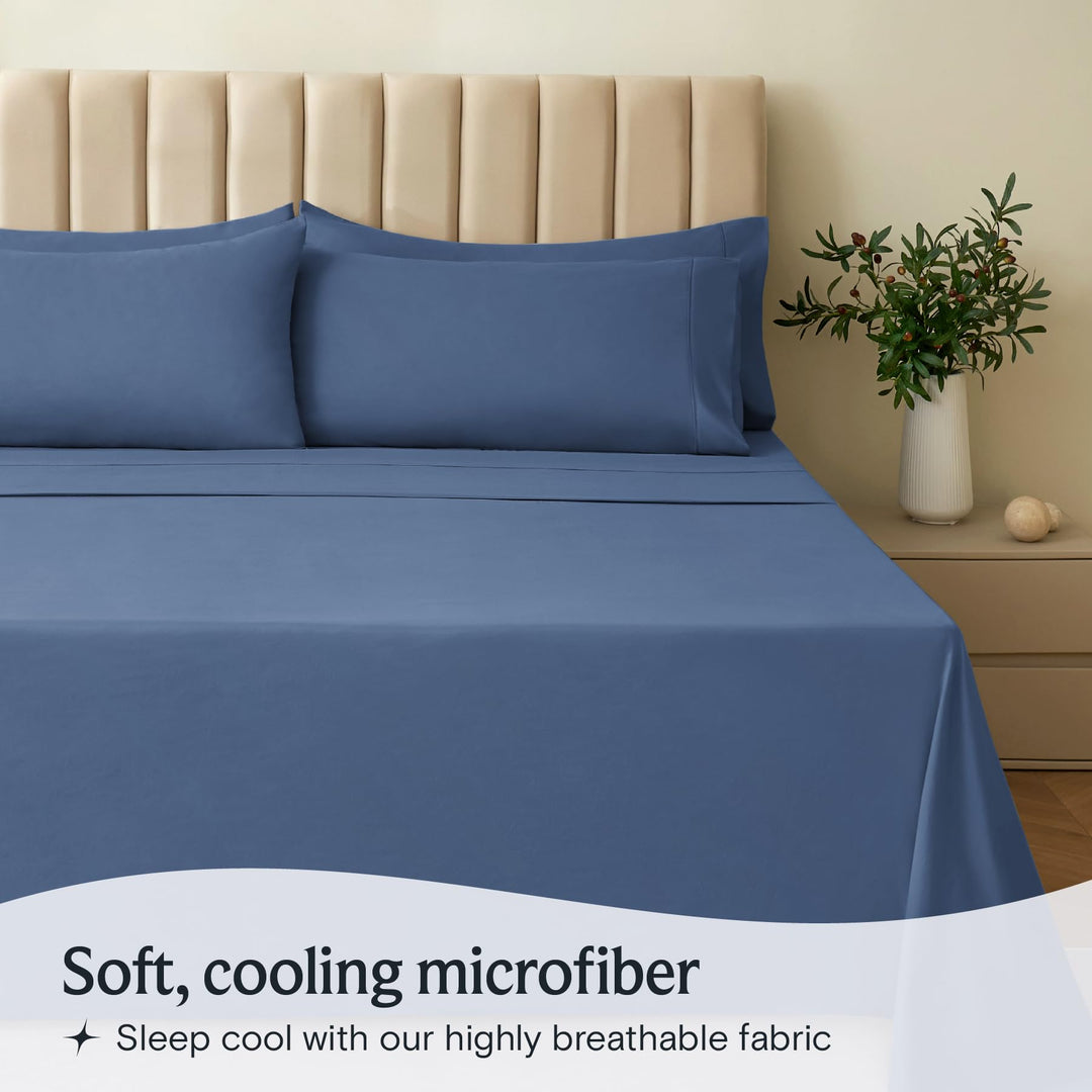 a bed with blue sheets and pillows with text: 'Soft, cooling microfiber Sleep cool with our highly breathable fabric'