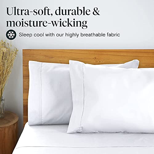 a bed with white sheets and a vase of dry flowers with text: 'Ultra-soft, durable & moisture-wicking Sleep cool with our highly breathable fabric'